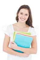 Portrait of cheerful female college student holding books