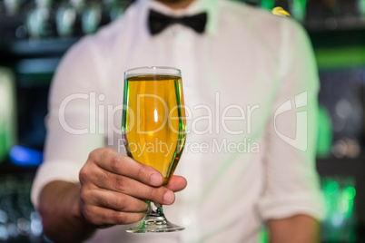 Bartender serving a glass of beer