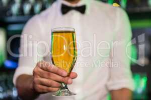 Bartender serving a glass of beer