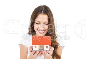 Happy woman holding miniature house