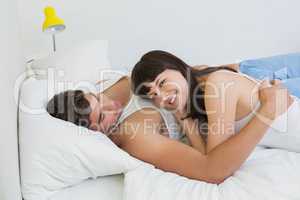 Young couple embracing on bed
