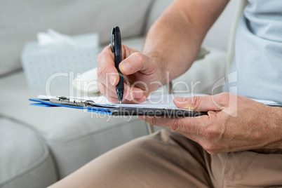 Man writing on notepad