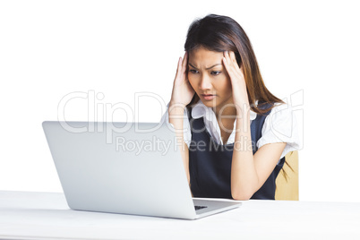 Nervous businesswoman using a laptop