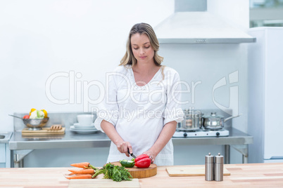 Pregnant woman busy in kitchen