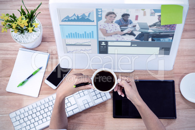 Composite image of editor holding tablet and smiling as team wor