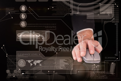 Composite image of businessman in suit using mouse