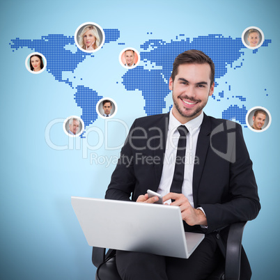 Composite image of happy businessman with laptop using smartphon