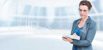 Composite image of businesswoman writing on clipboard