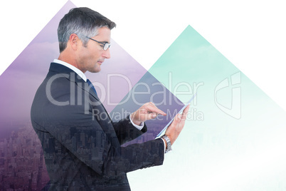 Composite image of mid section of a businessman touching tablet