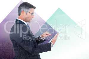 Composite image of mid section of a businessman touching tablet