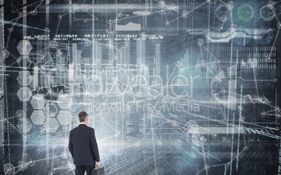 Composite image of businessman in suit looking through binocular