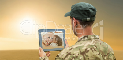 Composite image of soldier using tablet pc