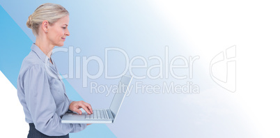 Composite image of businesswoman using laptop