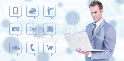 Composite image of businessman using laptop