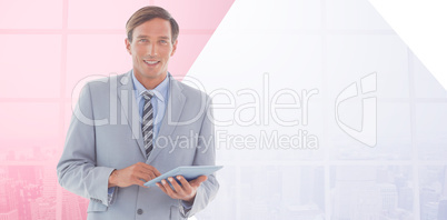 Composite image of happy businessman using tablet pc