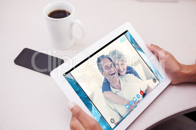 Composite image of woman using tablet pc