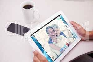 Composite image of woman using tablet pc