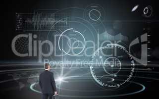 Composite image of businessman in suit looking through binocular