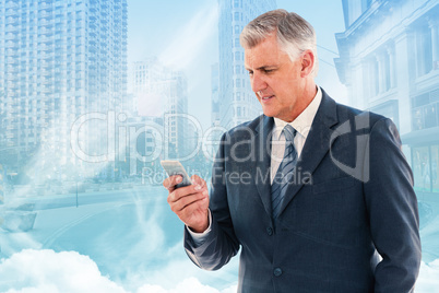 Composite image of businessman using his smartphone