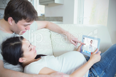 Composite image of prospective parents looking at ultrasound sca