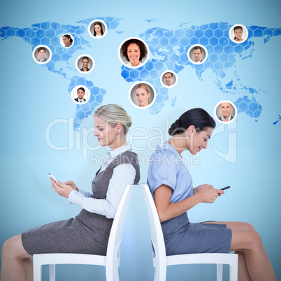 Composite image of businesswomen sitting back-to-back on the cha