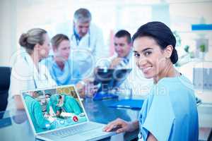 Composite image of beautiful smiling doctor typing on keyboard w