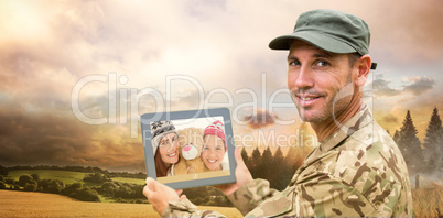 Composite image of soldier using tablet pc