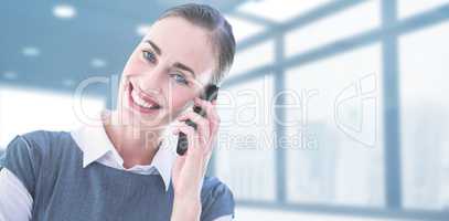 Composite image of portrait of businesswoman using mobile phone