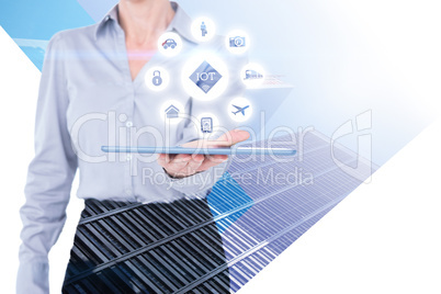 Composite image of businesswoman holding digital tablet