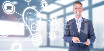 Composite image of portrait of smiling businessman using digital