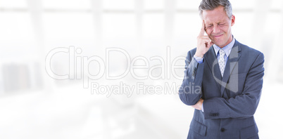 Composite image of businessman with headache