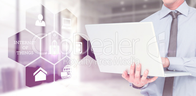 Composite image of businessman using a laptop