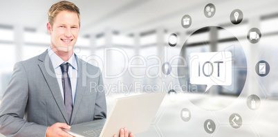 Composite image of happy businessman with laptop