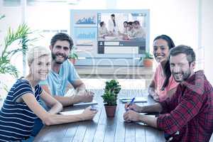 Composite image of friends sitting at a table