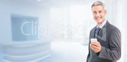 Composite image of portrait of smiling businessman holding mobil