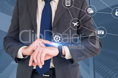 Composite image of businessman looking at watch
