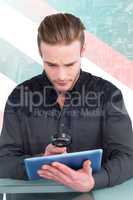 Composite image of businessman looking at digital tablet with ma