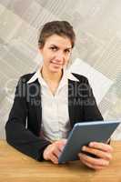 Composite image of businesswoman using her tablet pc