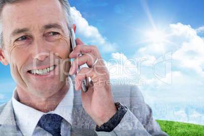 Composite image of buisnessman taking on mobile phone