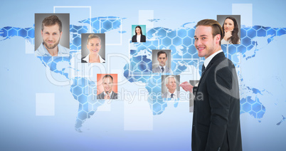 Composite image of smiling businessman gesturing and looking at