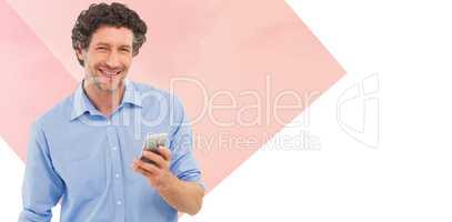 Composite image of businessman holding mobile phone over white b