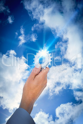 businessman holding a gear