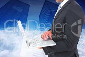 Composite image of businessman holding laptop