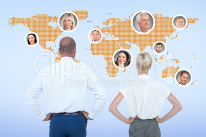 Composite image of  smiling business people with hands on the hi