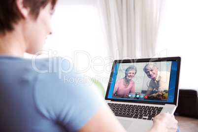 Composite image of pregnant woman using her laptop