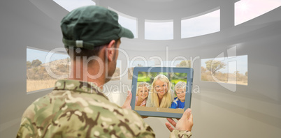 Composite image of soldier using tablet pc