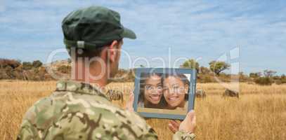 Composite image of soldier using tablet pc