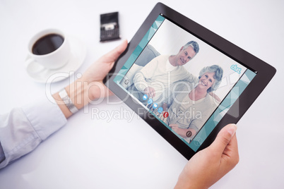 Composite image of man using tablet pc