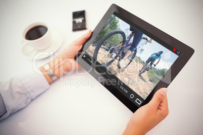 Composite image of man using tablet pc