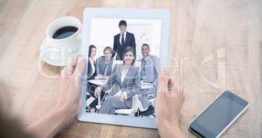 Composite image of woman using tablet computer at table